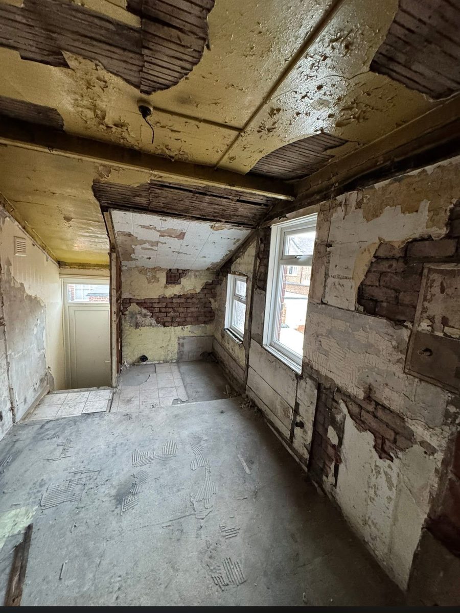 Derelict upper room stripped back to brick and bare boards