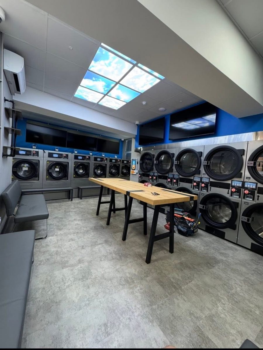 The finished launderette fit-out with machines installed and seating in place